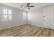 Bedroom with wood floors, ceiling fan and walk-in closet at 17440 W Eugene Ter, Surprise, AZ 85388