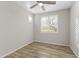 Cozy bedroom with wood-look flooring and a window with shutters at 17440 W Eugene Ter, Surprise, AZ 85388