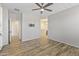 Bright bedroom with wood floors, ceiling fan and access to bathroom and hallway at 17440 W Eugene Ter, Surprise, AZ 85388