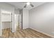 Bedroom with wood floors, ceiling fan and access to bathroom and closet at 17440 W Eugene Ter, Surprise, AZ 85388