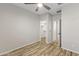 Bedroom with wood floors, ceiling fan and access to closet and bathroom at 17440 W Eugene Ter, Surprise, AZ 85388