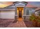 Attractive home exterior with a charming entryway and landscaping at 17440 W Eugene Ter, Surprise, AZ 85388