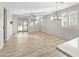 Spacious living room with wood-look floors and sliding doors to patio at 17440 W Eugene Ter, Surprise, AZ 85388