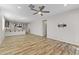 Open living room with wood floors, kitchen views, and ceiling fan at 17440 W Eugene Ter, Surprise, AZ 85388