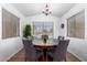 Bright dining room features a round wooden table with gray chairs and large windows at 1762 S Saddle St, Gilbert, AZ 85233