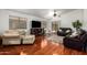 Spacious living area with hardwood floors and a TV at 1762 S Saddle St, Gilbert, AZ 85233