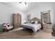 Spacious main bedroom with king-size bed, large wardrobe, and sitting chair at 1762 S Saddle St, Gilbert, AZ 85233