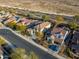 Residential area showcasing homes with tile roofs and desert landscaping at 17673 W Agave Rd, Goodyear, AZ 85338