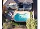 Aerial view of a backyard oasis featuring a sparkling pool, patio, and lush landscaping at 17673 W Agave Rd, Goodyear, AZ 85338