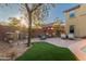 Outdoor kitchen, seating area, and putting green at 17673 W Agave Rd, Goodyear, AZ 85338