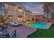 Relaxing backyard with pool, patio furniture, and lighting at 17673 W Agave Rd, Goodyear, AZ 85338