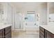 Double vanity bathroom with soaking tub and walk-in shower at 17673 W Agave Rd, Goodyear, AZ 85338