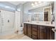 Bathroom with double vanity, tub shower combo, and tile flooring at 17673 W Agave Rd, Goodyear, AZ 85338