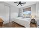 Bright bedroom with large window, ceiling fan, and neutral decor at 17673 W Agave Rd, Goodyear, AZ 85338