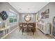 Bright dining room with a large table and statement mirror at 17673 W Agave Rd, Goodyear, AZ 85338