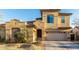 Two-story house with Spanish-style architecture, a three-car garage, and landscaped front yard at 17673 W Agave Rd, Goodyear, AZ 85338