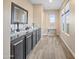 Bright hallway with built-in storage and hardwood floors at 17673 W Agave Rd, Goodyear, AZ 85338