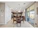 Kitchen nook with glass table and chairs, view to backyard at 17673 W Agave Rd, Goodyear, AZ 85338