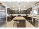 Modern kitchen with island and dark cabinetry at 17673 W Agave Rd, Goodyear, AZ 85338