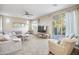 Spacious living room with comfy seating, large TV, and access to balcony at 17673 W Agave Rd, Goodyear, AZ 85338