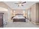 Spacious main bedroom with a king-size bed and ceiling fan at 17673 W Agave Rd, Goodyear, AZ 85338
