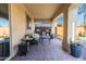 Covered patio with seating and a view of the pool at 17673 W Agave Rd, Goodyear, AZ 85338