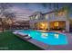Stunning pool and patio area with outdoor lighting, perfect for relaxing evenings at 17673 W Agave Rd, Goodyear, AZ 85338