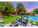 Inviting backyard featuring a fire pit, pool, and ample green space at 17918 N 95Th St, Scottsdale, AZ 85255