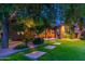 Landscaped backyard with a view of the house at dusk at 17918 N 95Th St, Scottsdale, AZ 85255