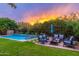 Relaxing backyard with a pool, fire pit, and comfortable seating area at 17918 N 95Th St, Scottsdale, AZ 85255