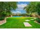 Landscaped backyard oasis with a large pool and spacious lawn at 17918 N 95Th St, Scottsdale, AZ 85255