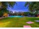 Serene backyard with a refreshing pool and beautifully manicured lawn at 17918 N 95Th St, Scottsdale, AZ 85255