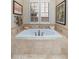 Bathroom with a luxurious soaking tub and large window at 17918 N 95Th St, Scottsdale, AZ 85255