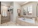 Spa-like bathroom with a soaking tub and shower at 17918 N 95Th St, Scottsdale, AZ 85255