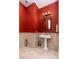 Small bathroom with pedestal sink and red painted walls at 17918 N 95Th St, Scottsdale, AZ 85255