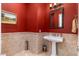 Small bathroom with pedestal sink and red painted walls at 17918 N 95Th St, Scottsdale, AZ 85255