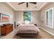 Bright bedroom featuring a king bed and plantation shutters at 17918 N 95Th St, Scottsdale, AZ 85255