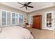 Main bedroom with king bed, sitting area and French doors at 17918 N 95Th St, Scottsdale, AZ 85255