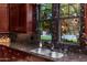 Kitchen features double sink, granite counters, and dark wood cabinets at 17918 N 95Th St, Scottsdale, AZ 85255