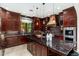 Spacious kitchen featuring granite countertops and dark wood cabinetry at 17918 N 95Th St, Scottsdale, AZ 85255
