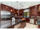 Eat-in kitchen with breakfast bar, granite counters, and stainless steel appliances at 17918 N 95Th St, Scottsdale, AZ 85255