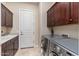 Laundry room with washer, dryer, and wooden cabinets at 17918 N 95Th St, Scottsdale, AZ 85255