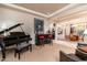 Elegant living room featuring a baby grand piano and bar area at 17918 N 95Th St, Scottsdale, AZ 85255