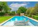 Stunning pool with built-in seating and a tranquil water feature at 17918 N 95Th St, Scottsdale, AZ 85255