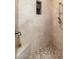 Walk-in shower with pebble floor and built-in seat at 17918 N 95Th St, Scottsdale, AZ 85255