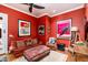 Cozy sitting area with a leather couch and red walls at 17918 N 95Th St, Scottsdale, AZ 85255