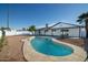 Kidney shaped pool with stone coping and surrounding yard at 2074 E Dunbar Dr, Tempe, AZ 85282