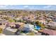 Aerial view of a home with backyard pool, a green lawn, and three car garage at 2161 E Flintlock Way, Chandler, AZ 85286