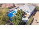 Aerial view of a home with backyard pool, a green lawn, and covered patio at 2161 E Flintlock Way, Chandler, AZ 85286