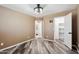 Bedroom with wood-look flooring and view of bathroom and closet, providing a glimpse of additional features at 2161 E Flintlock Way, Chandler, AZ 85286
